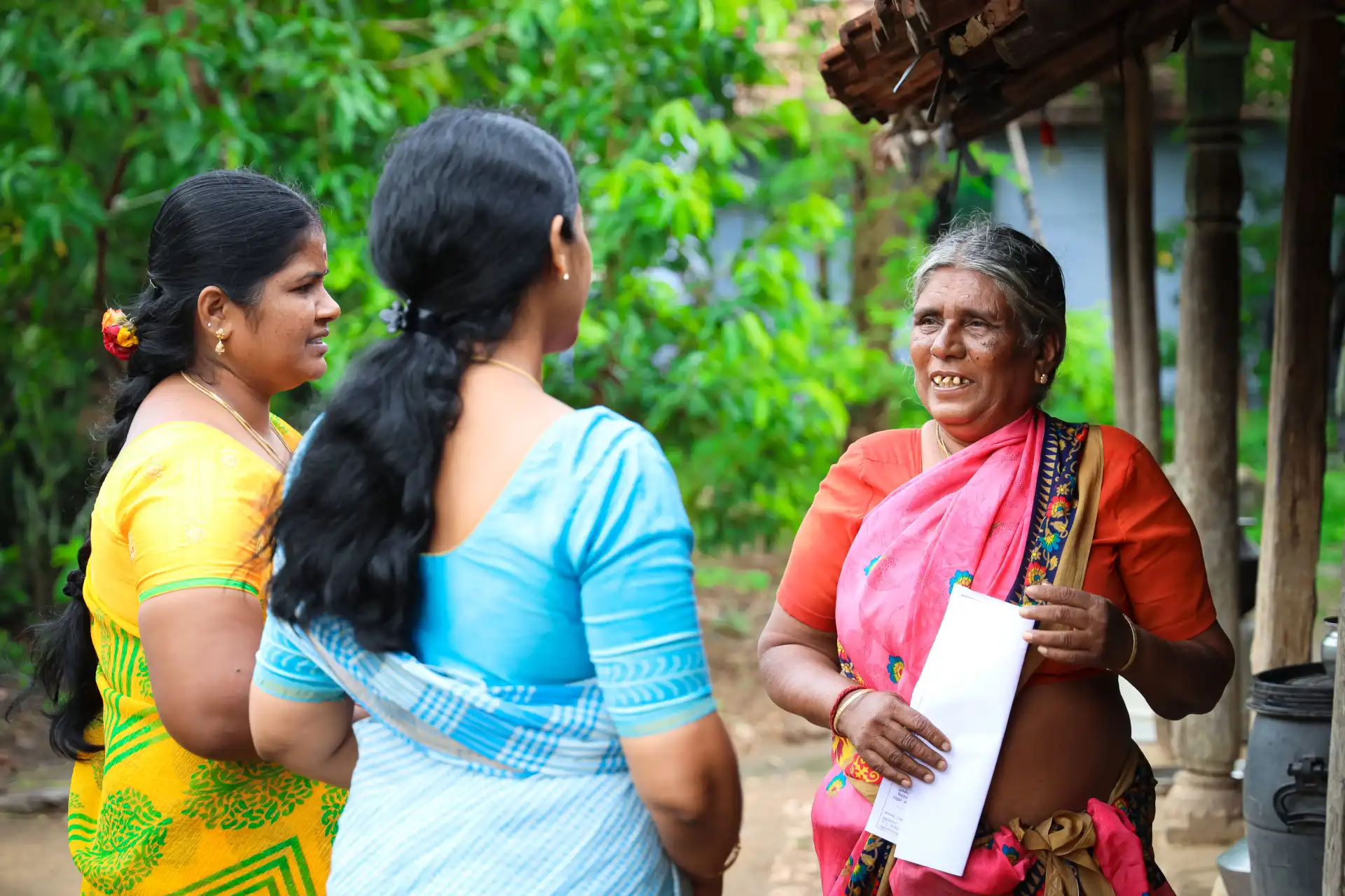 SMILE Kerala volunteer assisting an elderly woman in the community
