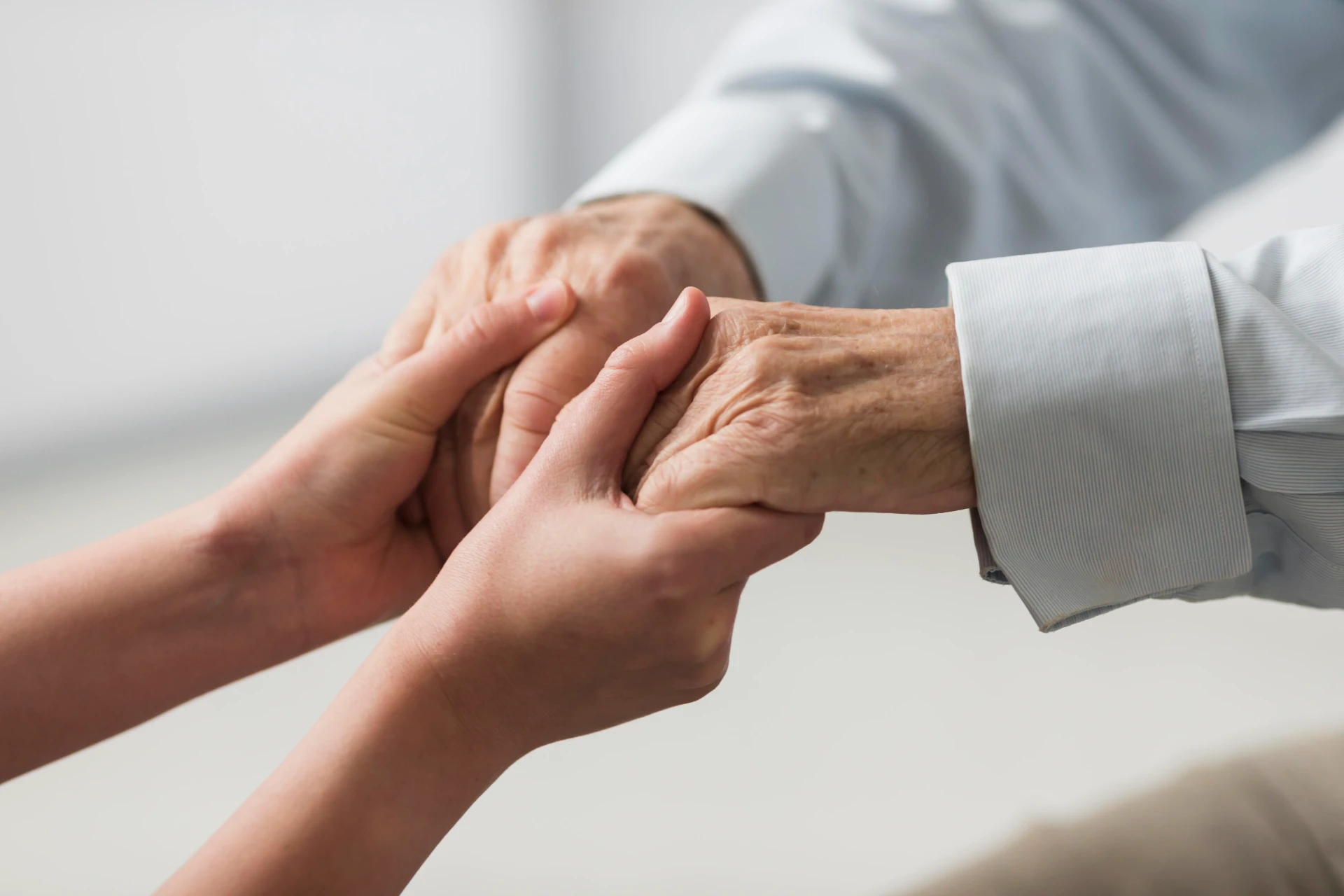 A healthcare worker checking on an elderly woman as part of Snehadhara