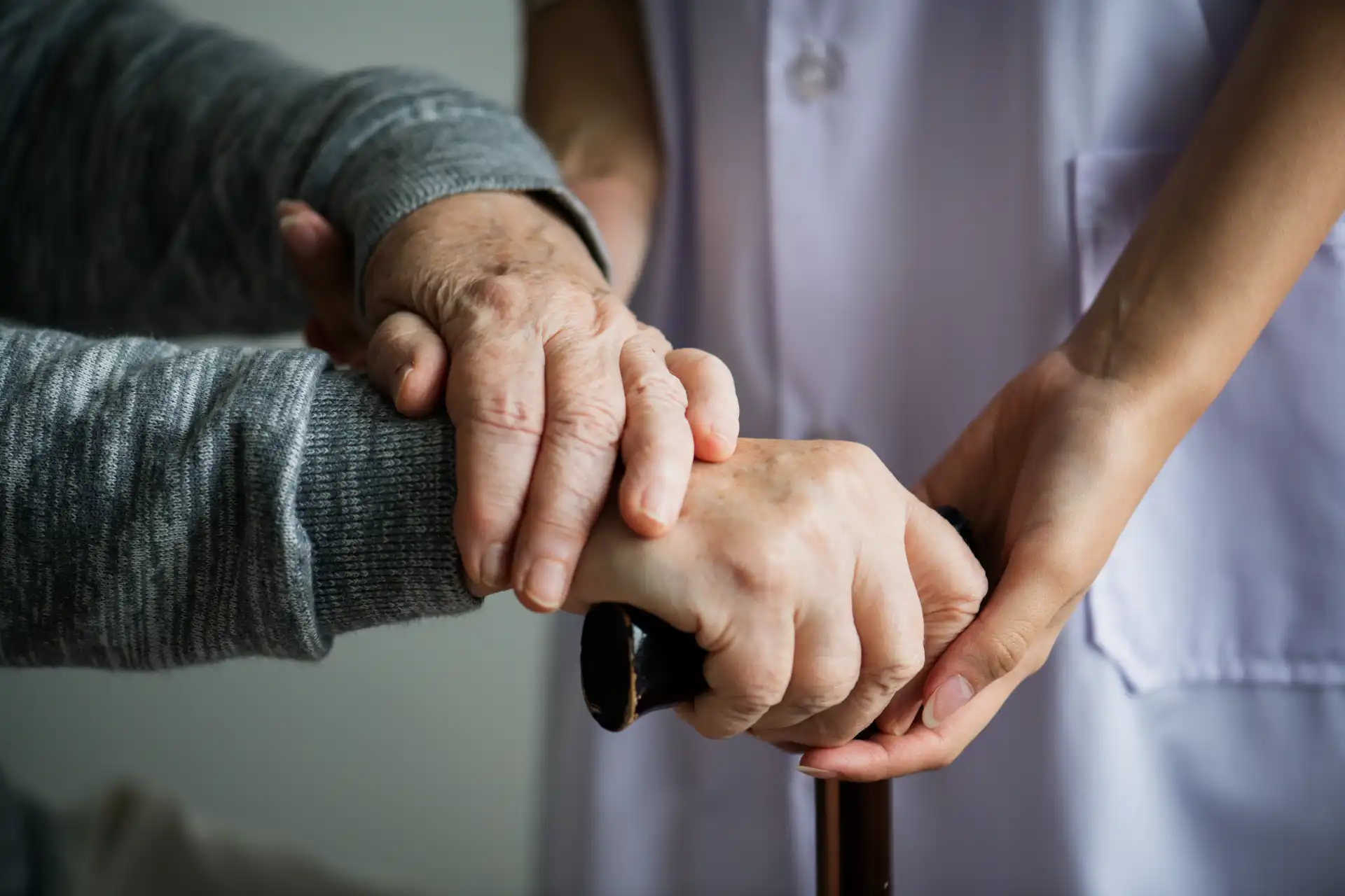 A healthcare worker attending to an elderly woman at home