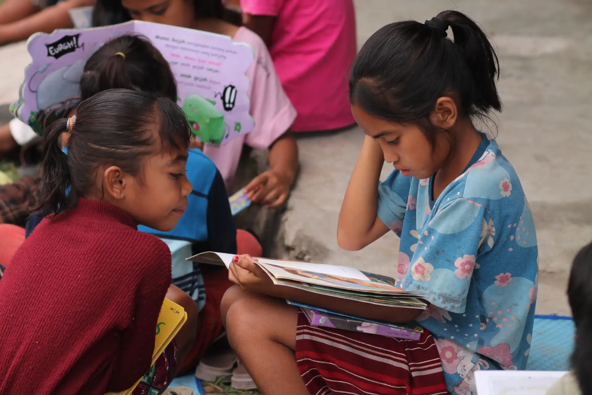 Children using a tablet at a SMILE Learning Centre